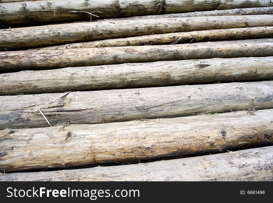 Background made of many long woodpiles in stack. Background made of many long woodpiles in stack