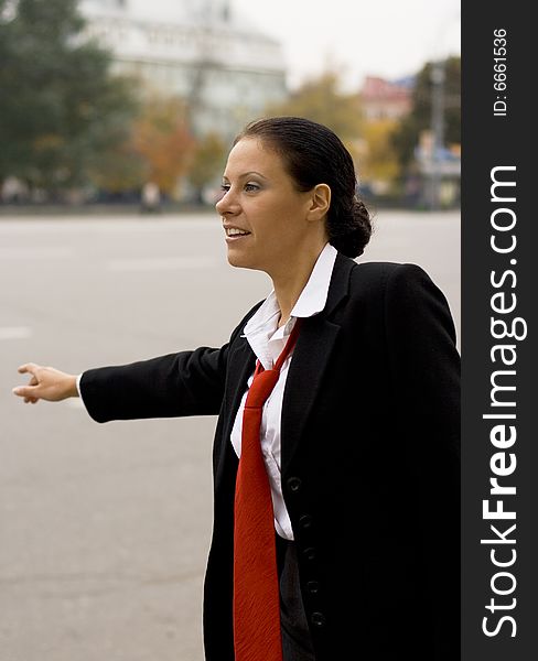 Portrait of pretty hitchhiking businesswoman