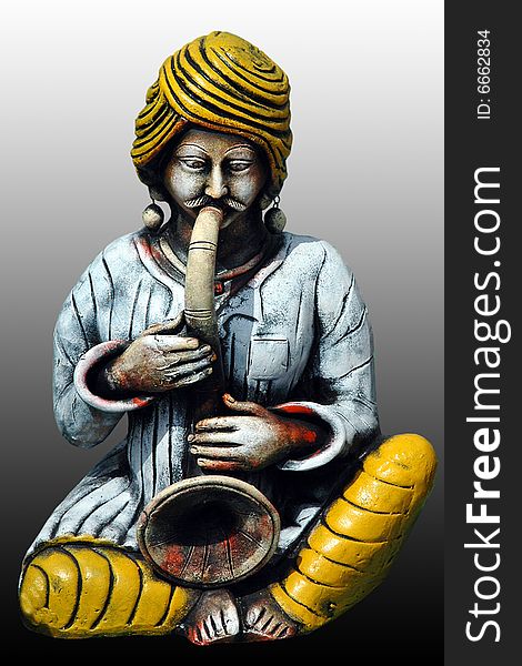 This beautiful, colorful craft is made from clay. A man playing Shahnai - an indian musical instrument. This beautiful, colorful craft is made from clay. A man playing Shahnai - an indian musical instrument.