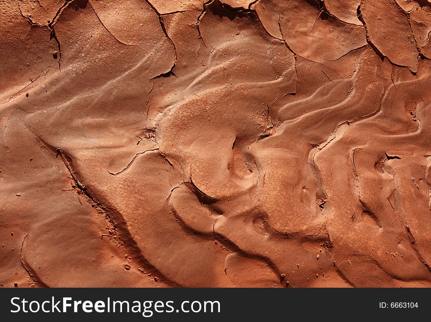 Ripples in drying reddish mud in red rock country. Ripples in drying reddish mud in red rock country