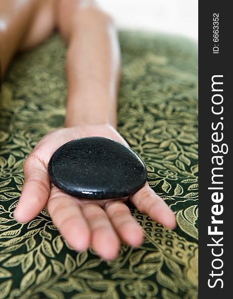Photo of warm stone massage. Photo of warm stone massage