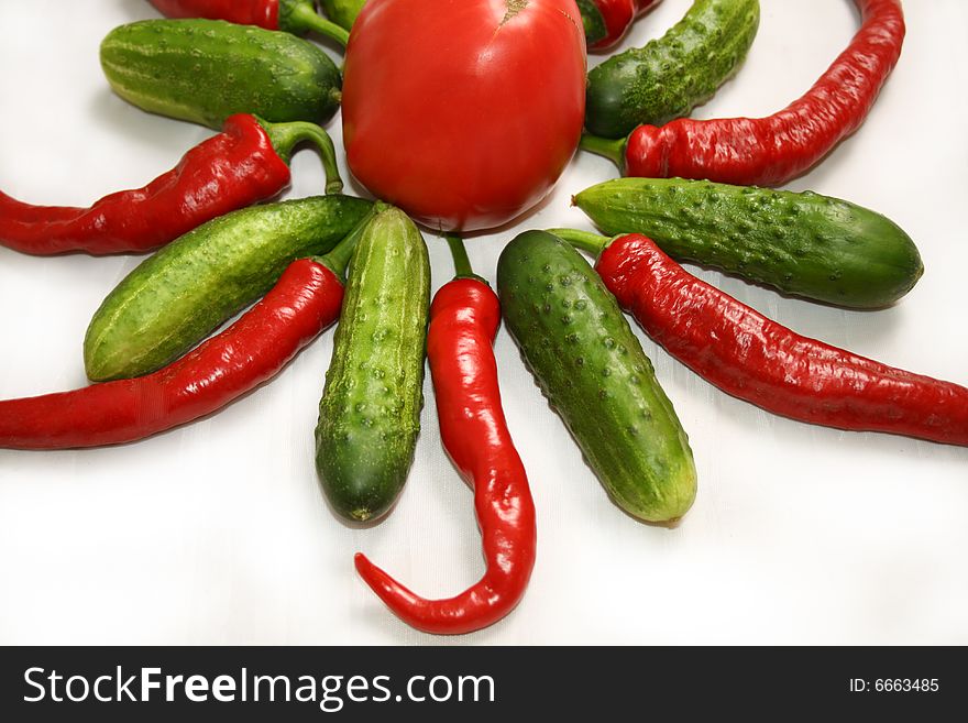 Chilies, Tomato and Cucumbers arranged in a star. Chilies, Tomato and Cucumbers arranged in a star