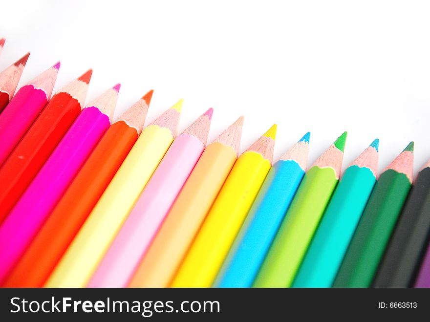 Assortment of coloured pencils with shadow on white background. Assortment of coloured pencils with shadow on white background