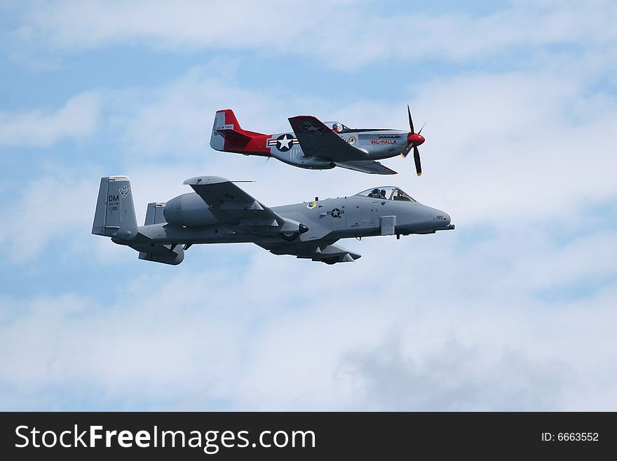The A-10 tank killer in flight showing off its moves and P52 mustang along side it. the old and the new. The A-10 tank killer in flight showing off its moves and P52 mustang along side it. the old and the new