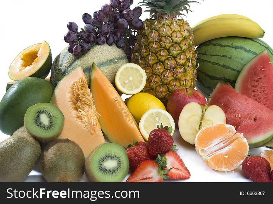 A heap of cut tropical fruits on a white background, very colorful image