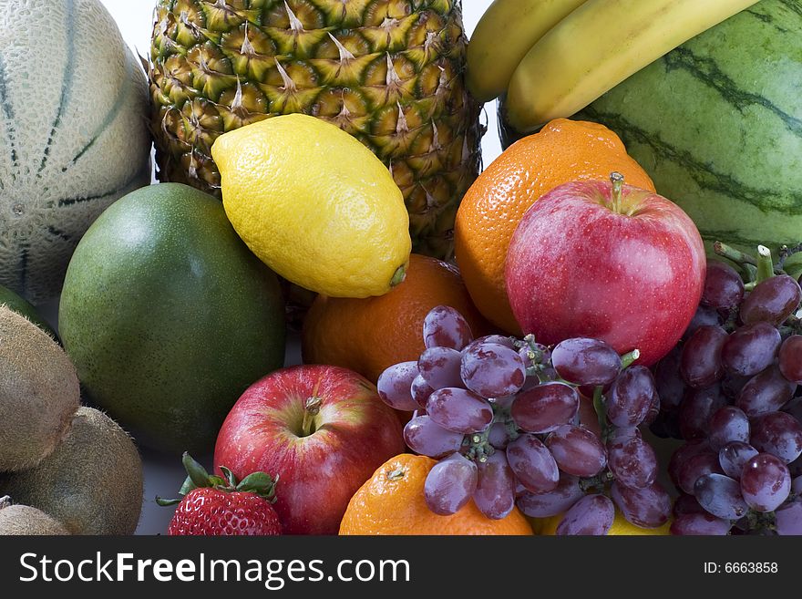 A heap of cut tropical fruits on a white background, very colorful image