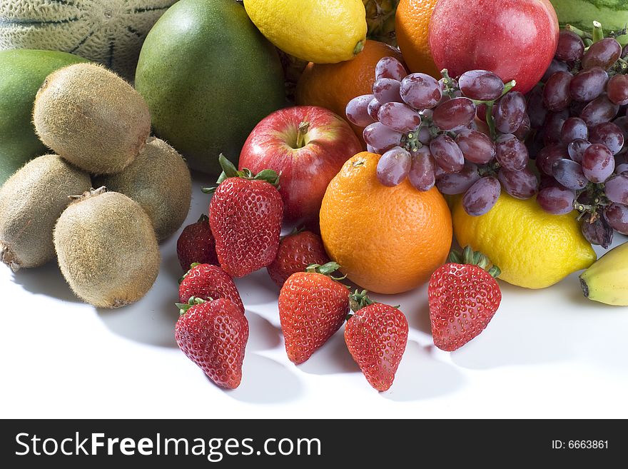 A heap of cut tropical fruits on a white background, very colorful image