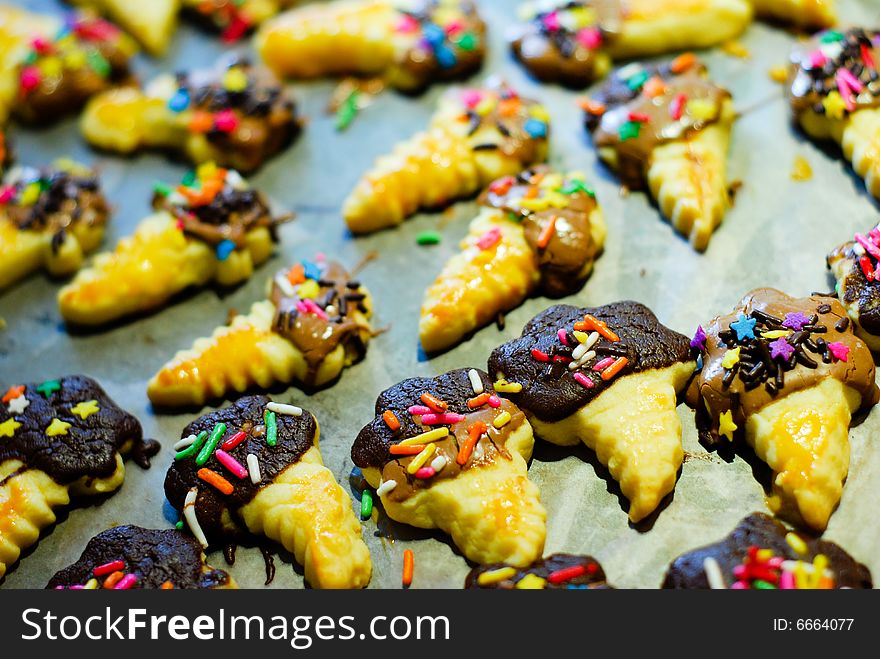 Homemade ice-cream shaped cookies with chocolate top and colored sprinkles. Homemade ice-cream shaped cookies with chocolate top and colored sprinkles.