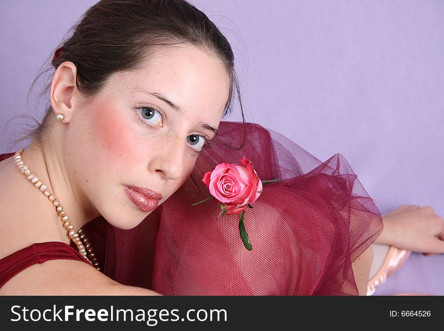 Teenage ballet dancer in a burgundy costume. Teenage ballet dancer in a burgundy costume