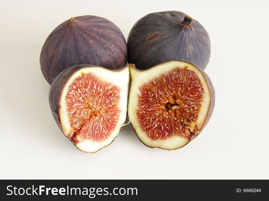 Two whole figs and one cut in half. Two whole figs and one cut in half