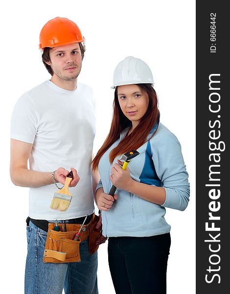 Young pair in a builder uniform with tools. Young pair in a builder uniform with tools.