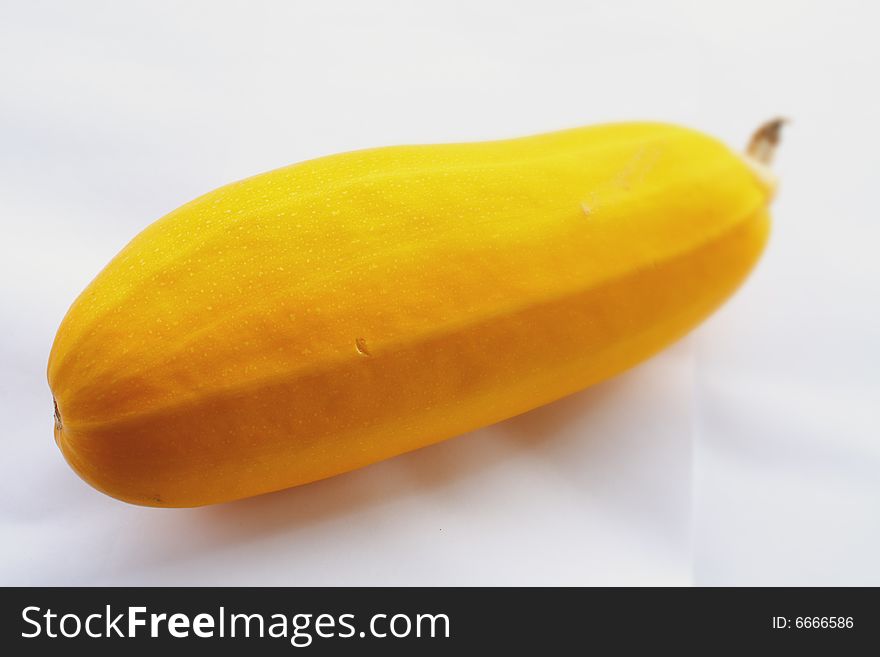 Yellow vegetable marrow on a white background small depth of sharpness