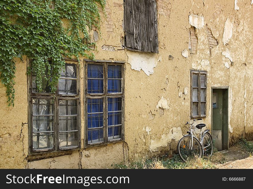 Old house facade, windows and bicycle
