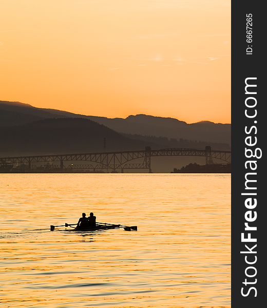 A pair of rowers captured on the water at daybreak. A pair of rowers captured on the water at daybreak.