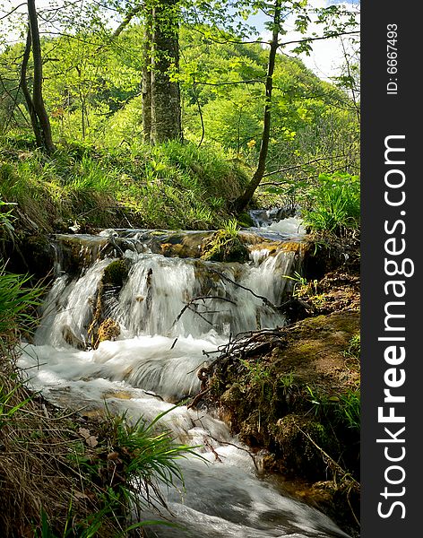 Small waterfall on a stream in mountain resort