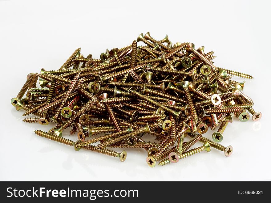 A pile screws on bright background. A pile screws on bright background