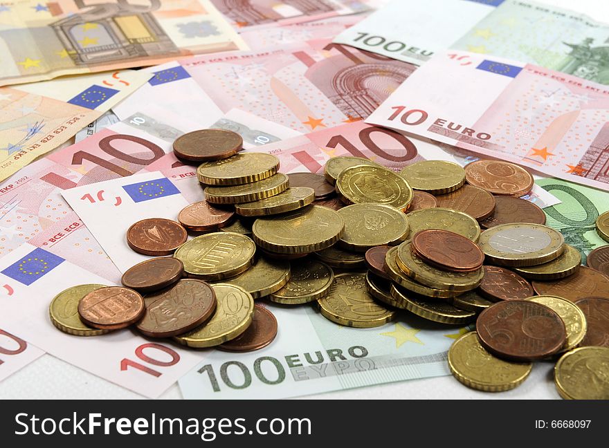 Euro coins falling on euro banknotes, isolated. Euro coins falling on euro banknotes, isolated