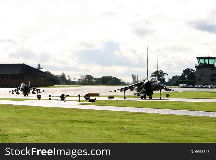 Twp RAF Harriers taxi to the active at RNAS Yeovilton. Twp RAF Harriers taxi to the active at RNAS Yeovilton