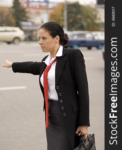 Portrait of pretty hitchhiking businesswoman
