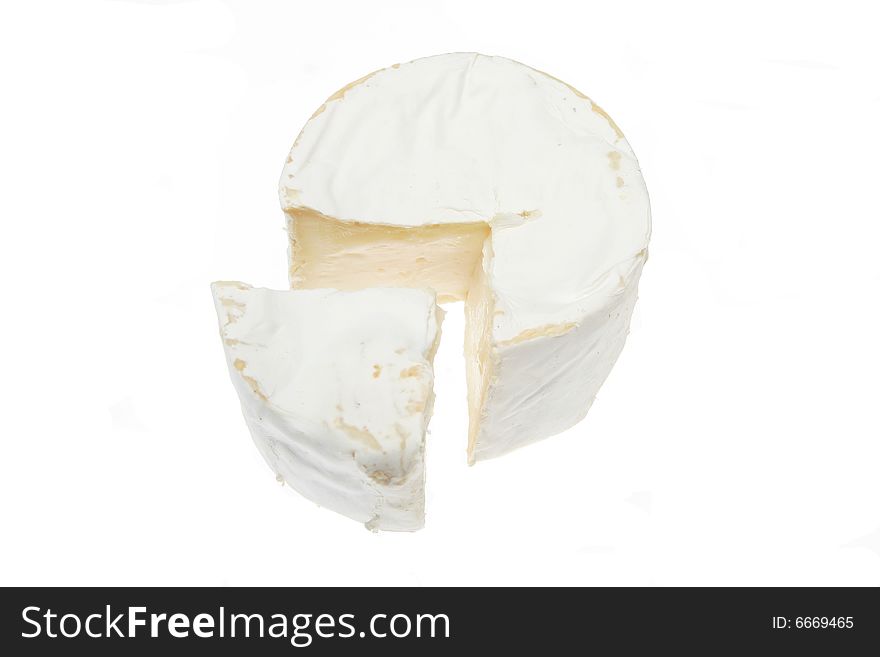 Round of soft cheese with wedge cut out. Round of soft cheese with wedge cut out