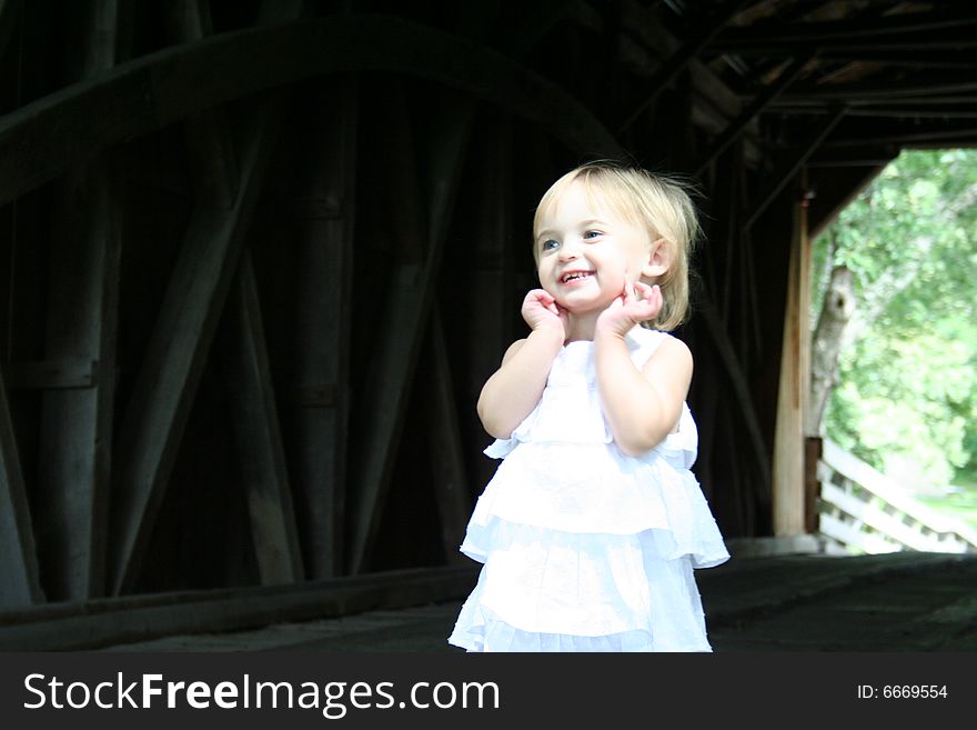 Little girl smiling on bridge. Little girl smiling on bridge