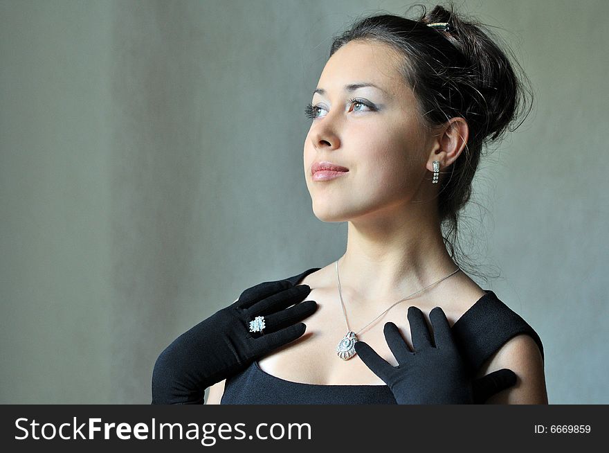 Beautiful model in a black dress with jewel. Beautiful model in a black dress with jewel