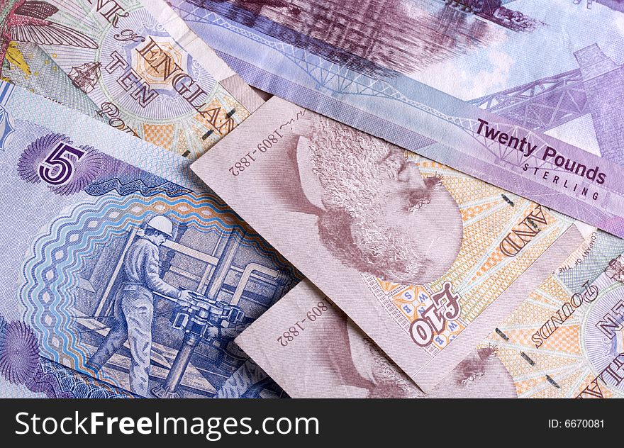 Mixed Scottish and English bank notes scattered around. Mixed Scottish and English bank notes scattered around