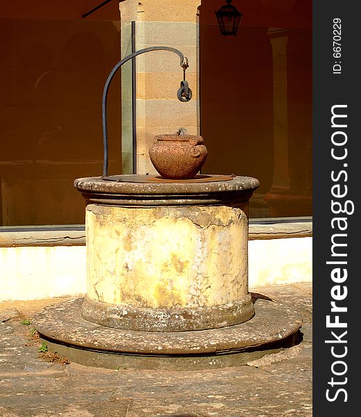 A beautiful shot of an ancient weel in a old cloister in Tuscany countryside