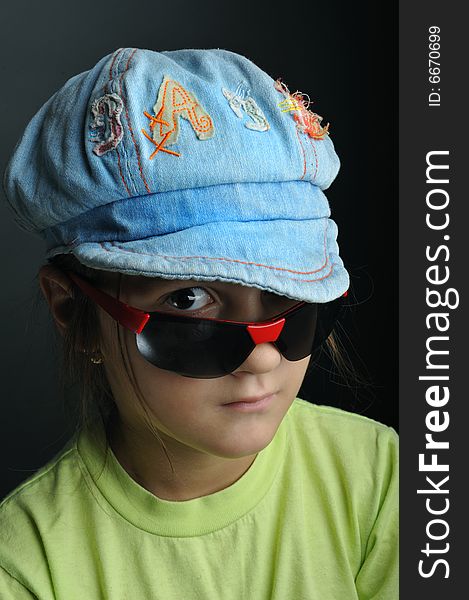 Portrait of a little girl with sunglasses and cap. Portrait of a little girl with sunglasses and cap