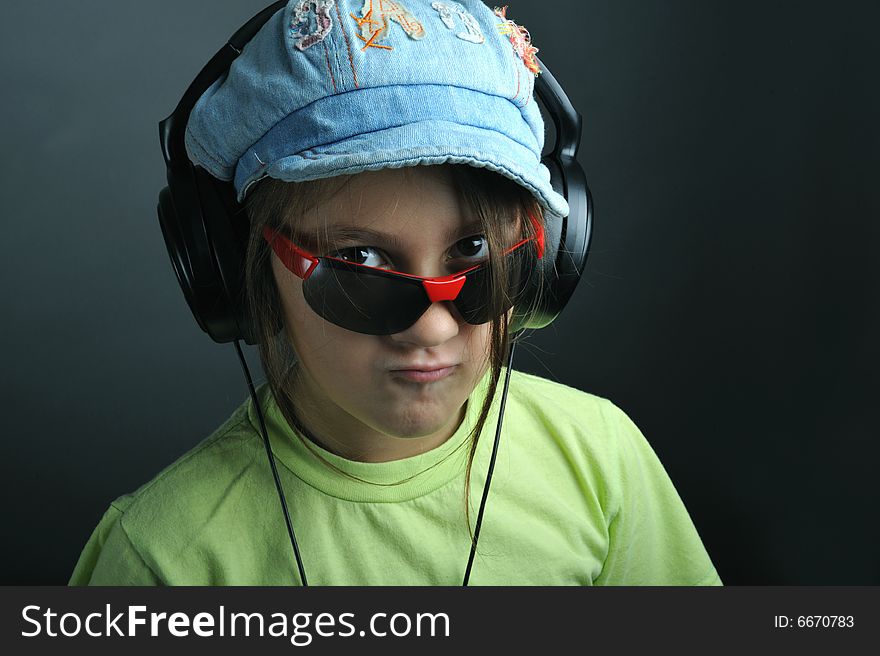 Portrait of a little girl with ear phones listening music