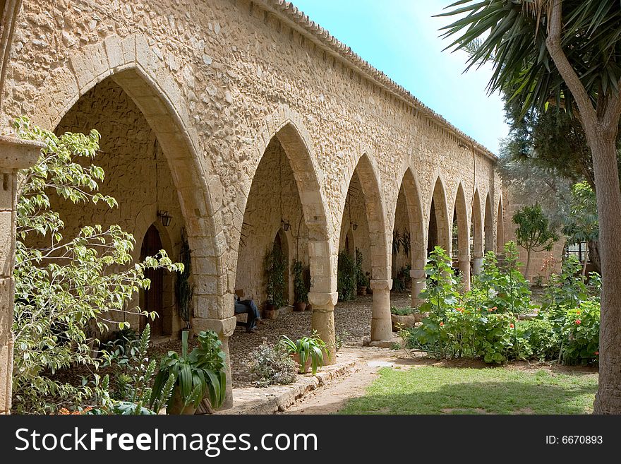 Passway between wall and pillars. Ancient architecture in Cyprus