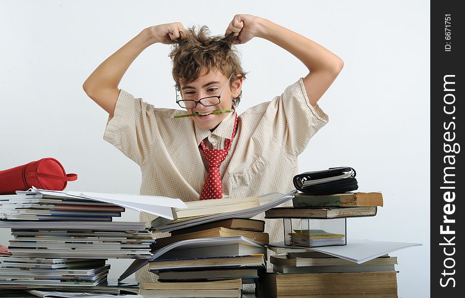 A teen behind of desk tearing his hair. A teen behind of desk tearing his hair