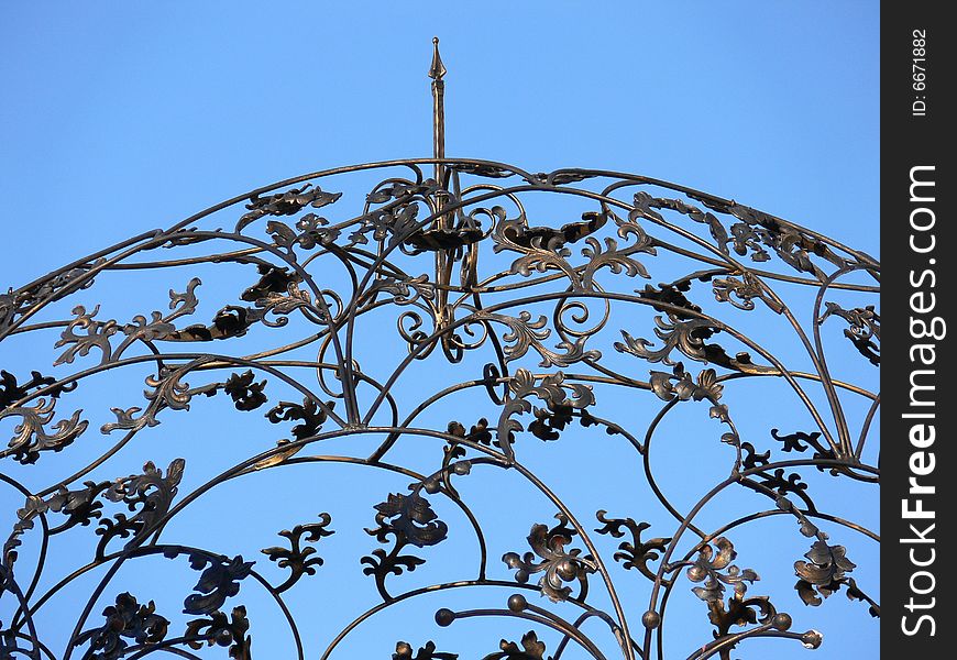 Iron Scrollwork roof on the blue background. Iron Scrollwork roof on the blue background