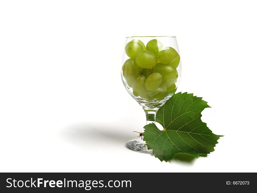 Cluster of glass with grapes on white background - close up