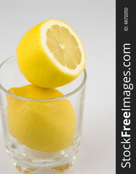 Lemons in a glass on white background