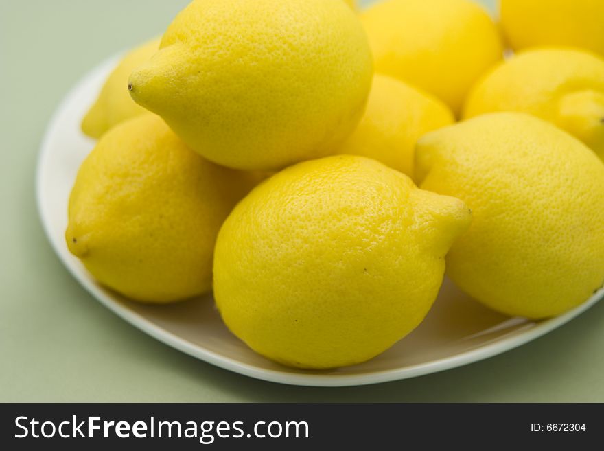 Plate full of Lemons on a table