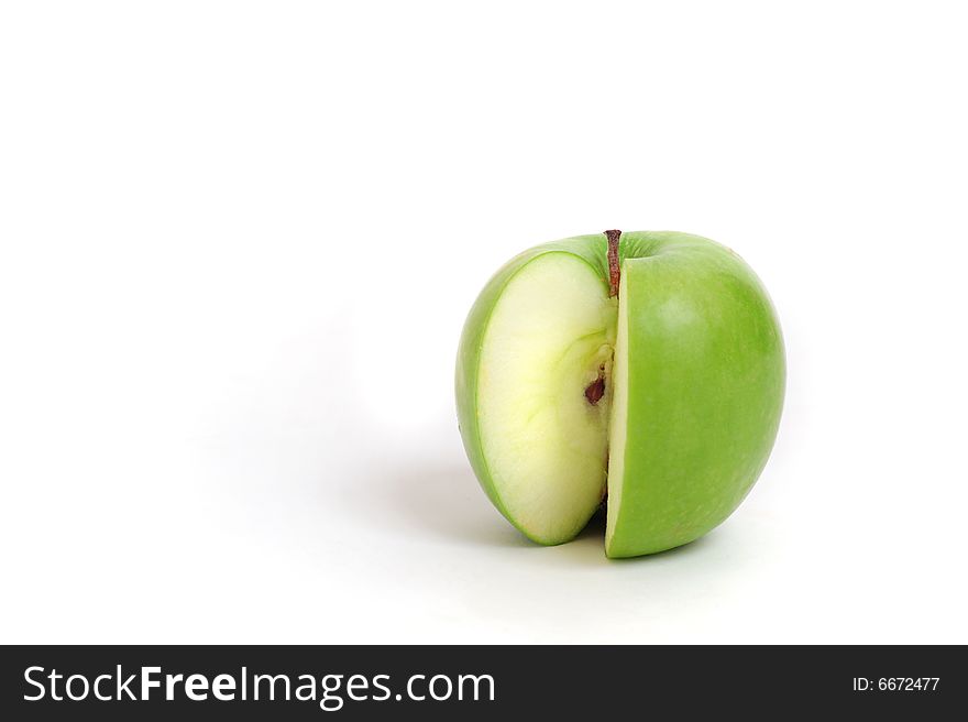 Close up of a green sliced apple on white background