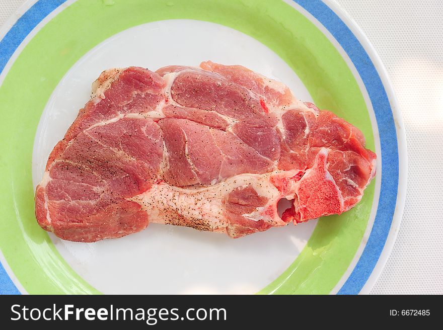 Raw of sruff meat on a plate, top view close up