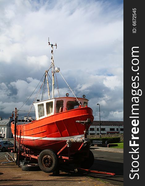 A boat pulled up for dry dock with the trailer set on blocks. A boat pulled up for dry dock with the trailer set on blocks