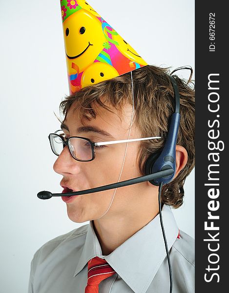 Young boy with party horn and hands-free phone device. Young boy with party horn and hands-free phone device