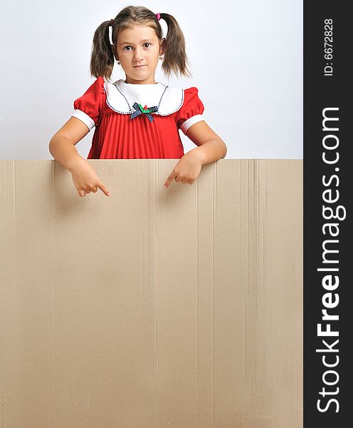 Little girl behind a blank cadboard (adequate for text), close up. Little girl behind a blank cadboard (adequate for text), close up