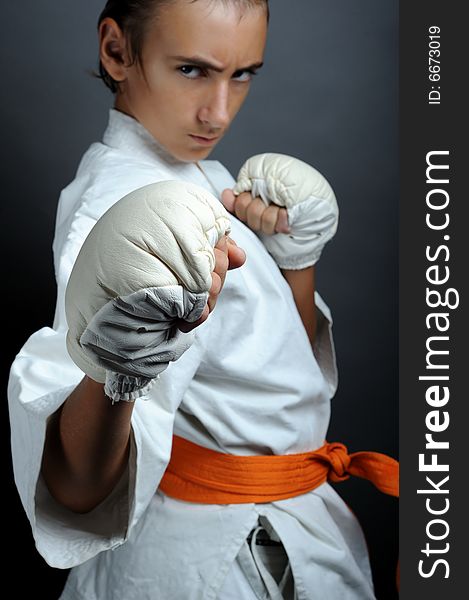 Boy in martial arts uniform doing karate. Boy in martial arts uniform doing karate