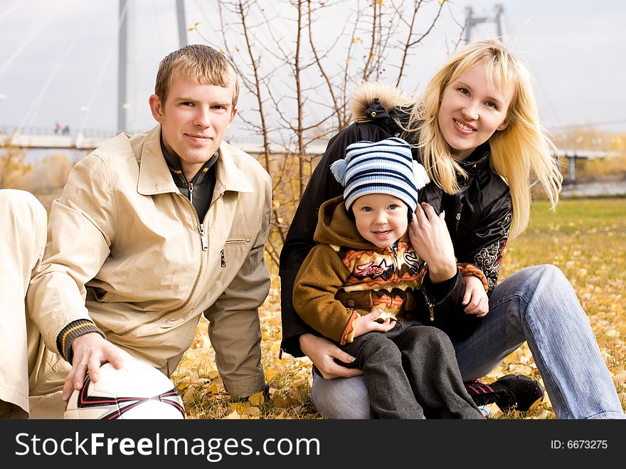 Happy smiling family with a football ball outdoor. Happy smiling family with a football ball outdoor
