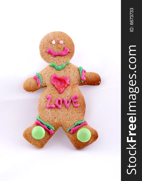 One gingerbread cookie with pink heart & the word love on it in icing. One gingerbread cookie with pink heart & the word love on it in icing