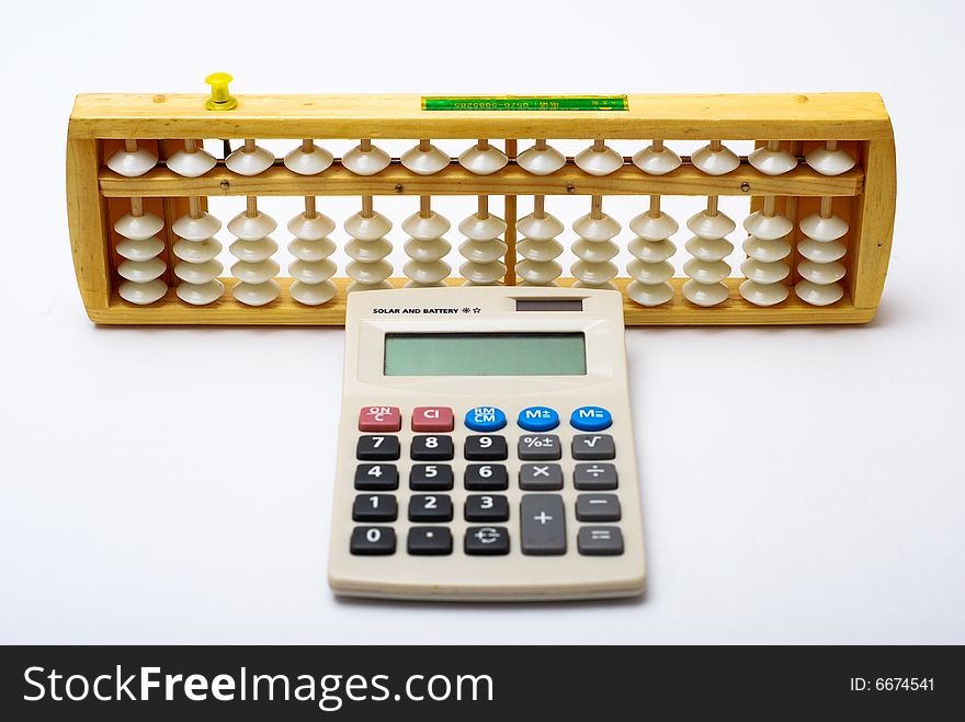 A traditional abacus and a modern calculator on white background. A traditional abacus and a modern calculator on white background