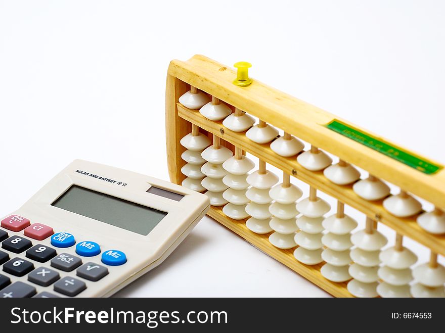 A traditional abacus and a modern calculator on white background. A traditional abacus and a modern calculator on white background