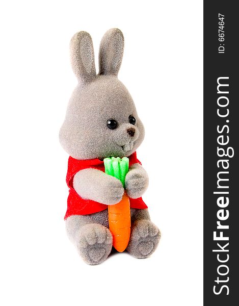 Toy rabbit with carrot isolated on white