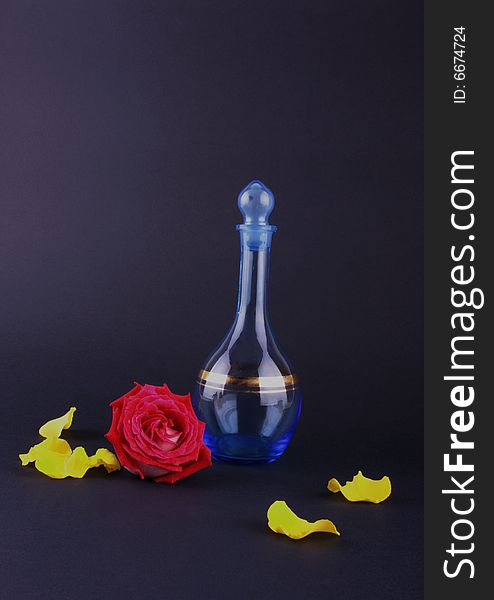 Blue bottle and rose head isolated