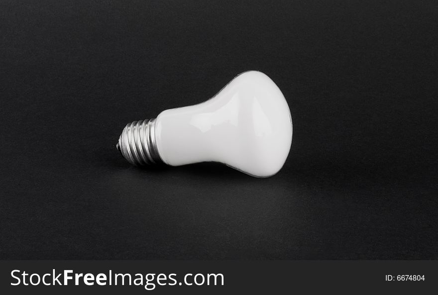 White lightbulb isolated on dark background