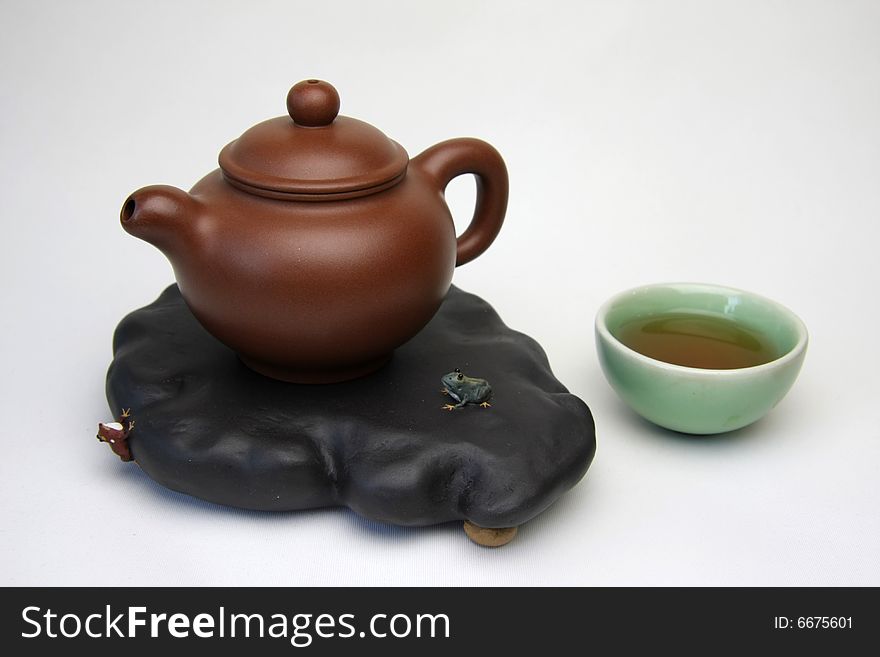 Teacup and teapot on white backgroundï¼Œalso called zisha teapot in China.